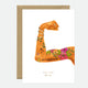 A greeting card with an illustration of a person's flexed bicep with floral tattoos and the text 'F***ing strong - YOU ARE the best' on it. The card is accompanied by a brown envelope.
