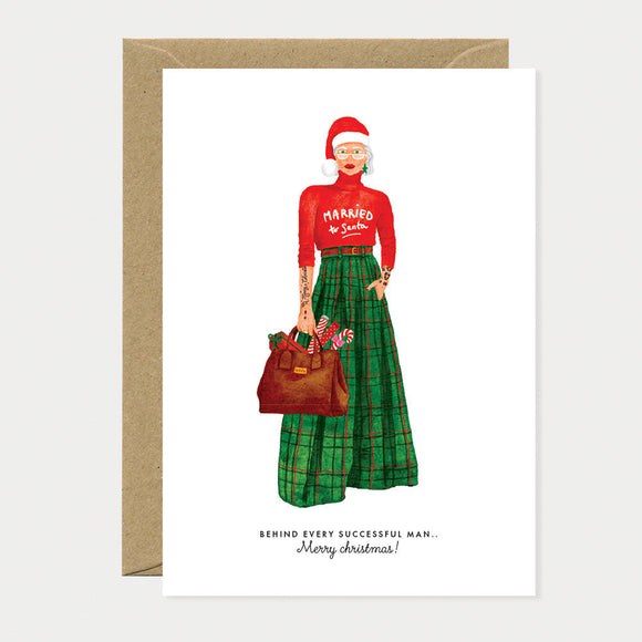 Greeting card featuring a modern Mrs. Claus in a chic green tartan skirt and red sweater with “Married to Santa” print, stylishly festive.
