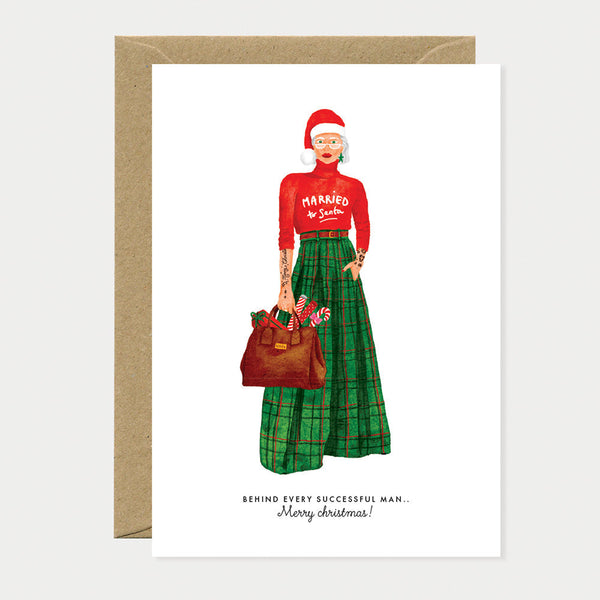 Greeting card featuring a modern Mrs. Claus in a chic green tartan skirt and red sweater with “Married to Santa” print, stylishly festive.