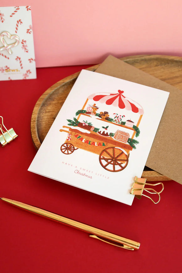 Sweet Little Christmas card by All The Ways To Say – festive illustrated card with gingerbread cart on red and pink background