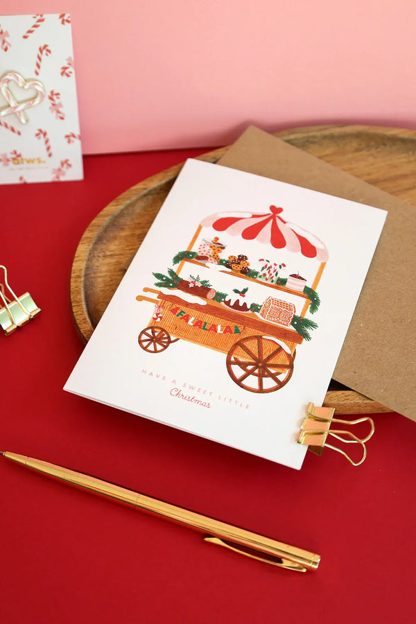 Sweet Little Christmas card by All The Ways To Say – festive illustrated card with gingerbread cart on red and pink background