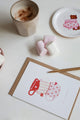 Greeting card Cup of Tea by All the Ways to Say featuring three tea cups in red and pink tones with heart motifs. Illustrated Valentine card with kraft envelope.