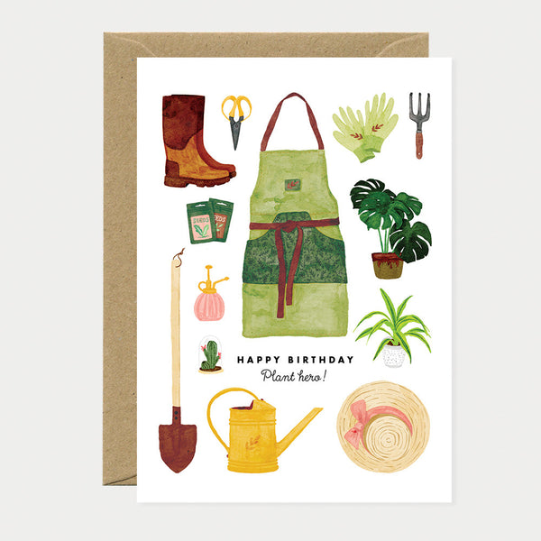 Greeting card with illustrations of gardening tools, apron, watering can, boots, gloves, and plants, arranged around the words "Happy Birthday Plant Hero".