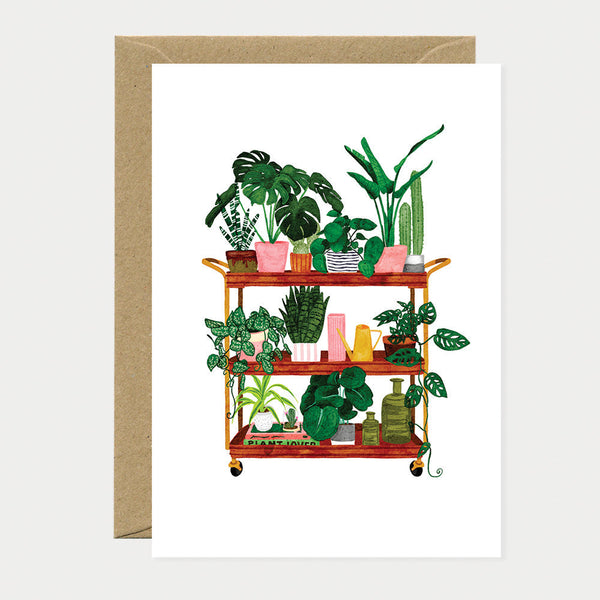 Greeting card showing a plant shelf cart filled with different houseplants, pots, and watering cans in a colorful botanical arrangement.