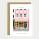 Illustration of a pink building with a striped awning on a greeting card.