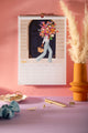 April page of the 2027 ATWS wall calendar: woman carrying a giant flower bouquet in front of a navy Paris door