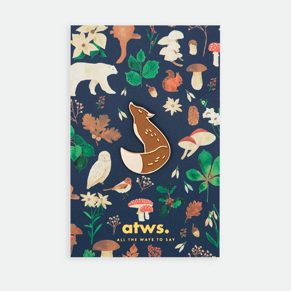 Brown Fox enamel pin by All the Ways to Say featuring gold-plated fox design on illustrated forest background with mushrooms, leaves and woodland animals.