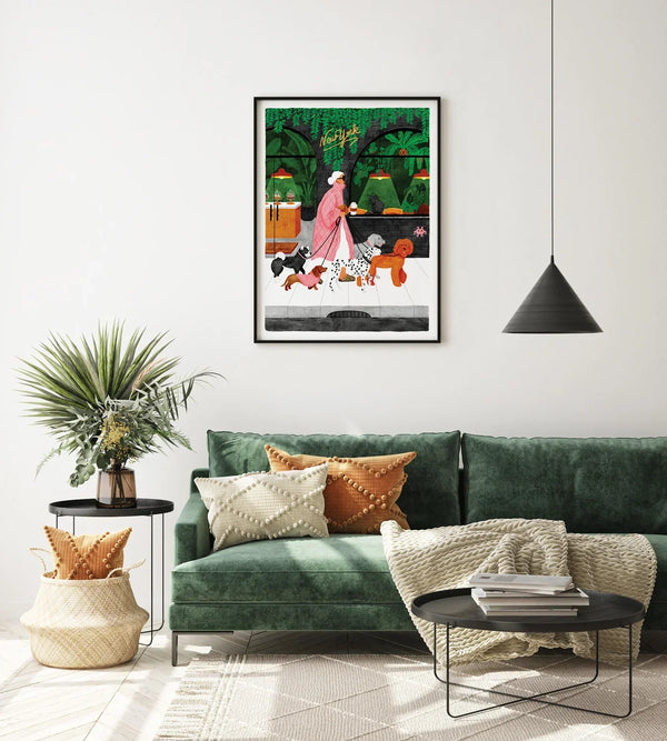 The Dog Sitter art print framed in a modern living room with green sofa and orange cushions