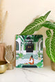 Travel Bucket List 2026 calendar by All The Ways To Say displayed with tropical plants and gold decor