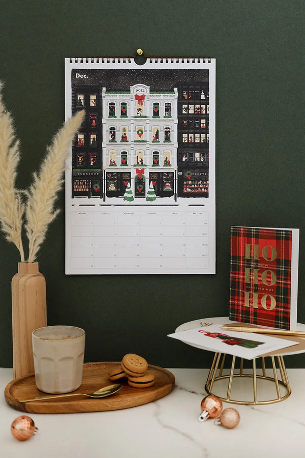 December page of Daily Poetry 2026 calendar – festive street with decorated shop windows