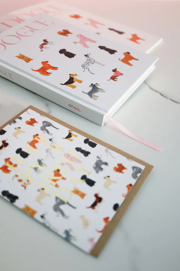 Dogue notebook with illustrated dogs styled on desk alongside matching greeting card for stationery lovers.