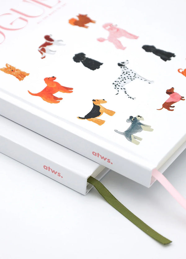 Close-up of Dogue hardcover notebook with illustrated dogs, stacked with another atws journal, ribbon bookmarks visible.