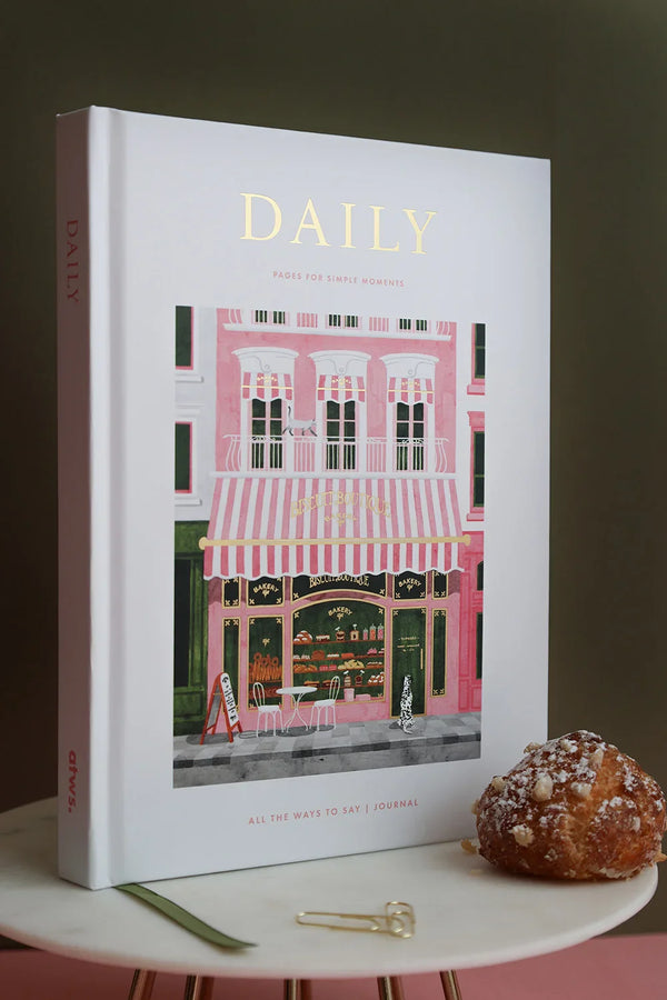 Daily Journal “Bakery” by All the Ways to Say shown with matching puzzle box and pastries, on a pink and olive background.