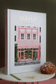 Daily Journal “Bakery” by All the Ways to Say shown with matching puzzle box and pastries, on a pink and olive background.