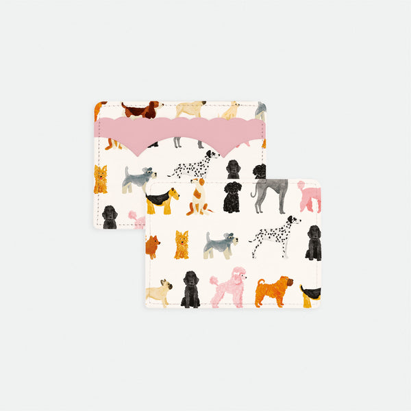 Dog print card holder with colorful illustrated dog breeds on white background and pink scalloped leather detail.