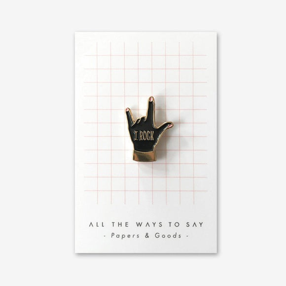 I Rock enamel pin by All the Ways to Say featuring black hand design with gold-plated finish and “I Rock” text, perfect for rock-inspired accessories.