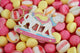 All The Ways To Say Wild Ride enamel keychain – spotted leopard on pink and yellow candy backdrop with pastel saddle