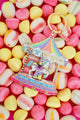 All The Ways To Say carousel keychain with gold details and pastel candy colors – playful flatlay