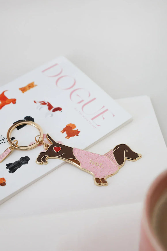 Playful Hot Dachshund enamel keychain by All The Ways To Say photographed with DOGUE card