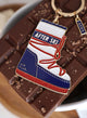 Close-up of After Ski enamel keychain – red, white and blue snow boot with glitter details