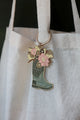 Plant Lover Boots keychain by All The Ways To Say hanging on canvas tote bag – floral enamel boot design