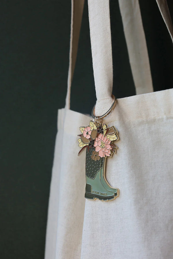 All The Ways To Say enamel keychain – green boot filled with pastel flowers and gold details