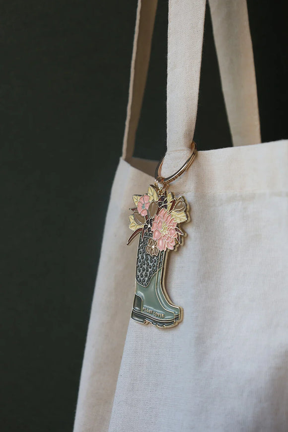 Close-up of Plant Lover Boots keychain by All The Ways To Say – floral bouquet in green boot with gold finish