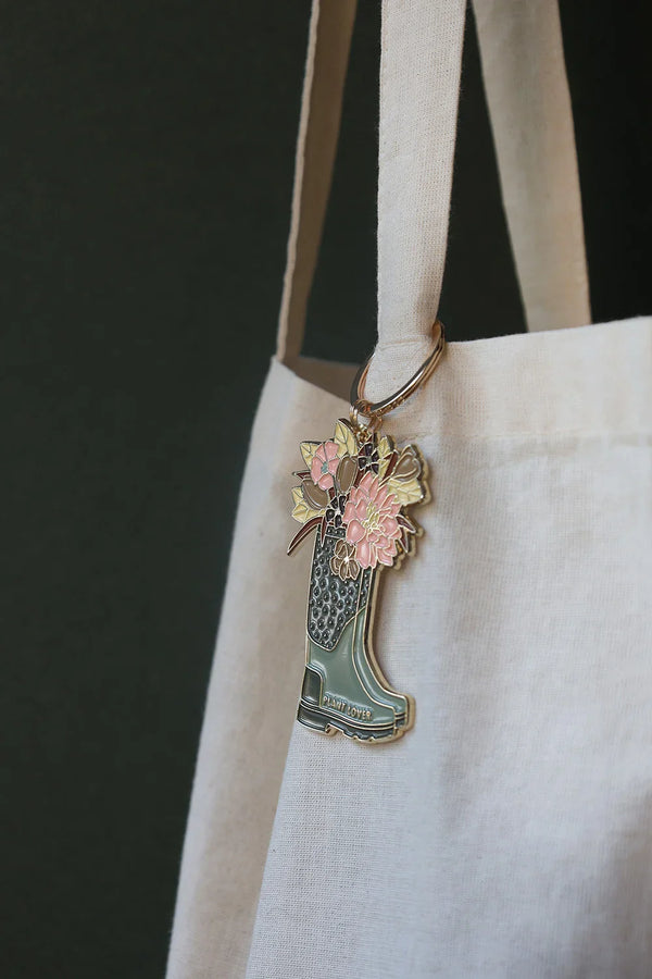 Close-up of Plant Lover Boots keychain by All The Ways To Say – floral bouquet in green boot with gold finish
