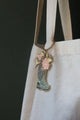 Close-up of Plant Lover Boots keychain by All The Ways To Say – floral bouquet in green boot with gold finish