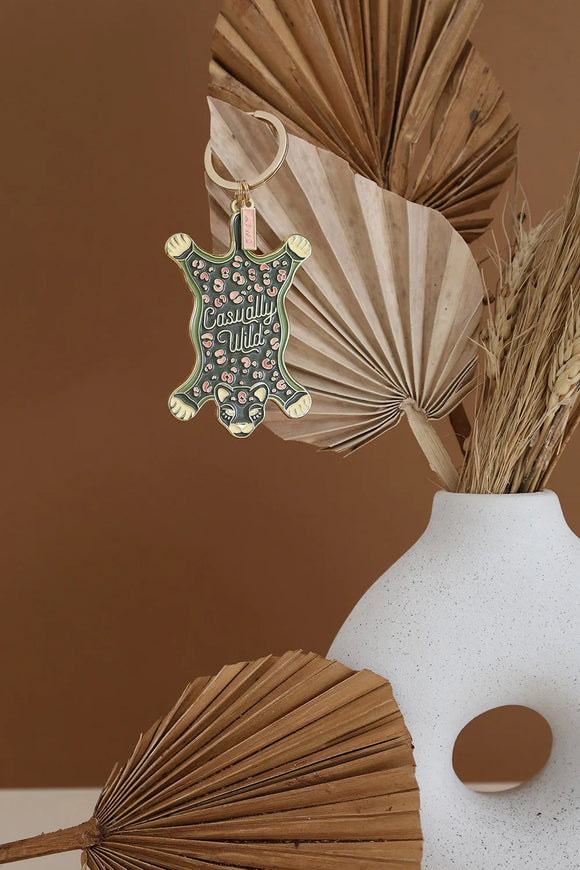 Leopard Carpet keychain by All The Ways To Say hanging on vase with dried palm leaves – wild chic decor
