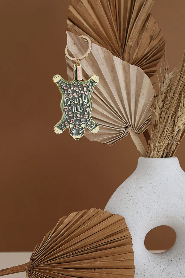 Leopard Carpet keychain by All The Ways To Say hanging on vase with dried palm leaves – wild chic decor