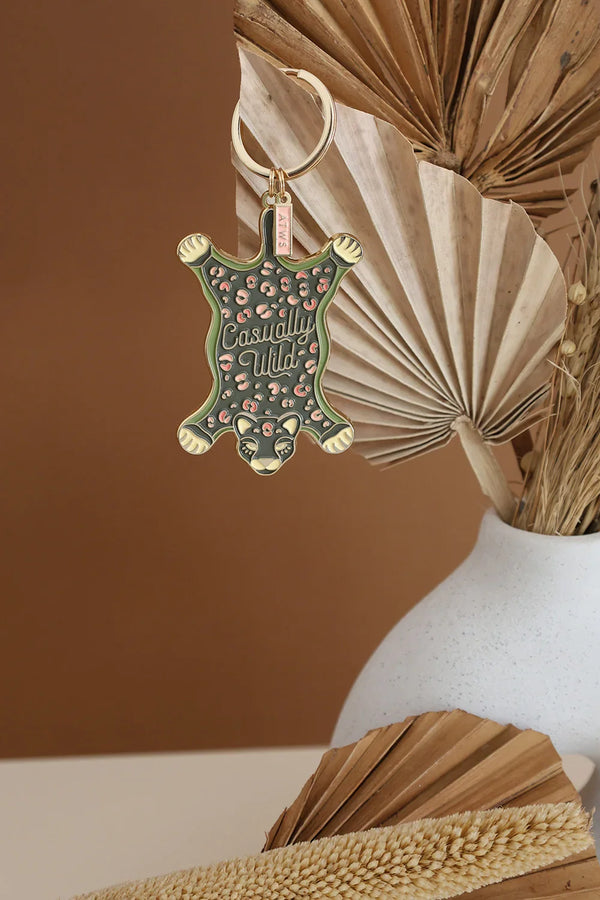 All The Ways To Say Casually Wild enamel keychain – leopard rug design in gold and green tones