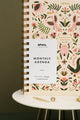 Front cover of Pink Croco monthly planner with white label and gold spiral binding