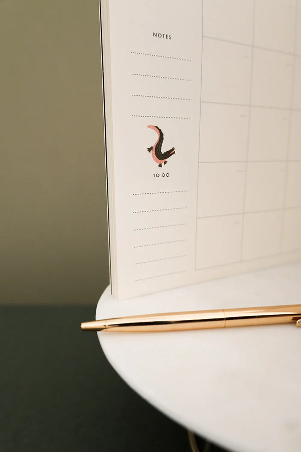 Interior Pink Croco monthly planner page with crocodile illustration near notes section
