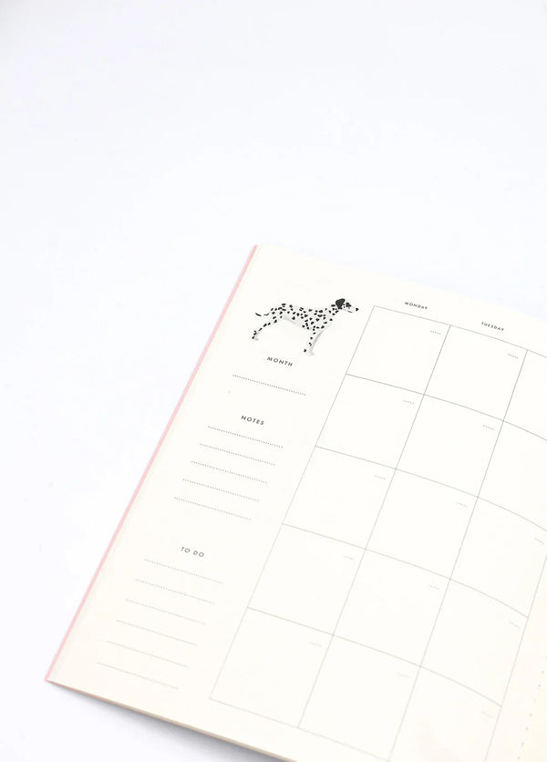 Inside page of Dogue monthly planner featuring a Dalmatian illustration with calendar layout