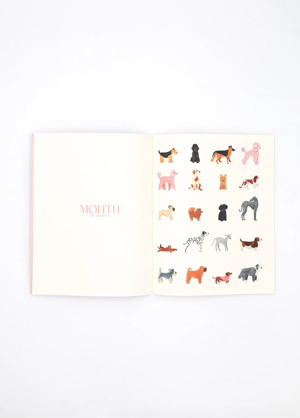 Dogue monthly planner open spread with colorful dog illustrations and “Month by Month” title