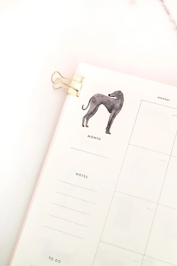 Close-up of the Dogue monthly planner showing a greyhound watercolor illustration and elegant minimalist layout.