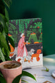 Dog Lover notebook featuring a woman walking dogs illustrated with green plants and cozy café scene – All the Ways to Say.