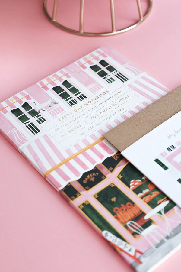 Every Day Notebook and birthday card with pink biscuit boutique illustration styled with pastries and coffee — All the Ways to Say stationery flat lay.