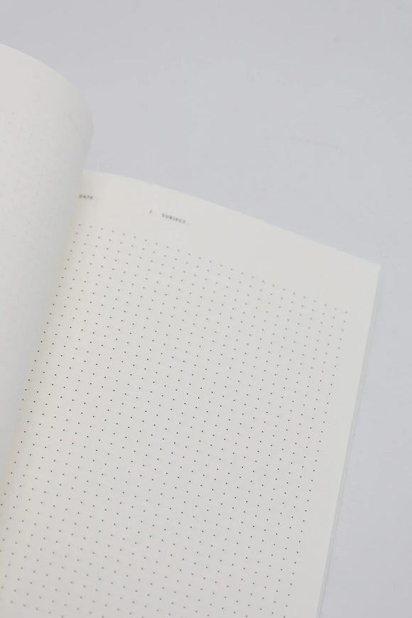Open dotted notebook page with minimal design, showing clean white paper for writing and journaling.