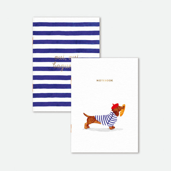 Set of two A6 pocket notebooks, one with dachshund in striped shirt and beret carrying a baguette, the other with blue stripes and gold lettering.