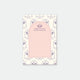 A notepad with a tennis-inspired design, featuring sports equipment and motifs in a pink color scheme.