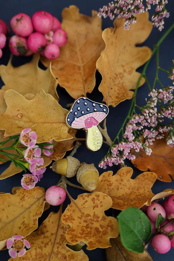 Crazy Mushroom enamel pin by All The Ways To Say on autumn leaves with acorns and pink flowers – forest-inspired flatlay
