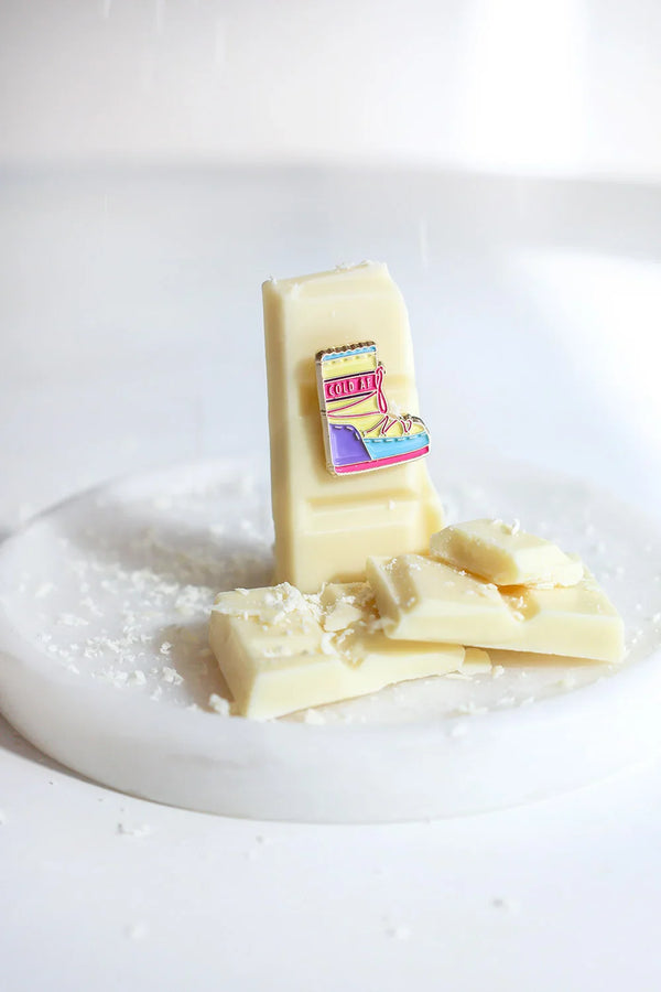 Cold AF enamel pin by All The Ways To Say – fun winter boot design on white chocolate with snow-like sprinkles