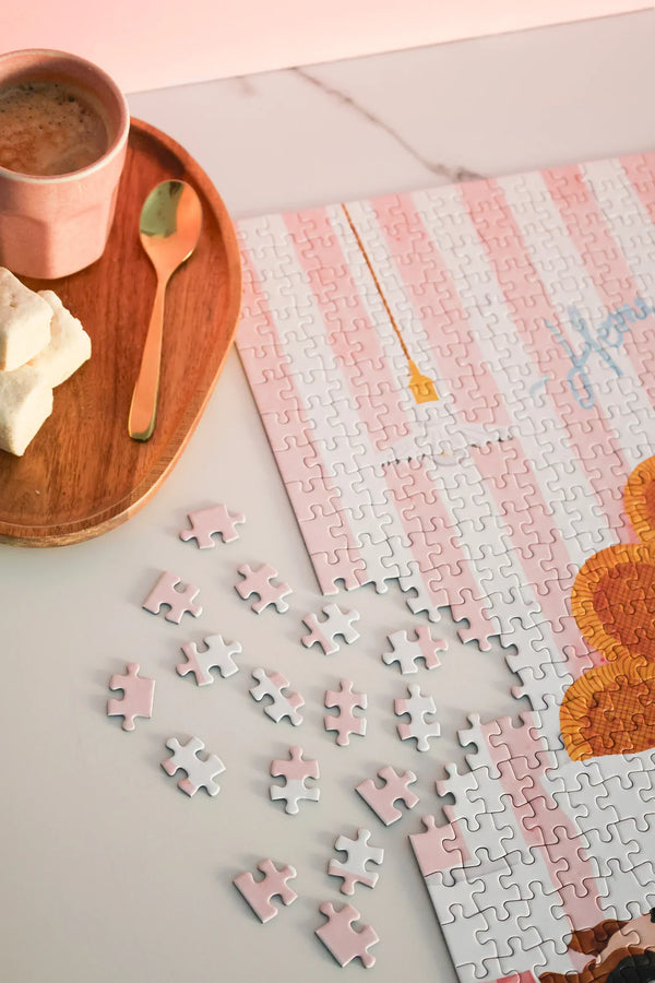 Home Sweet Home puzzle box with glass of rosé wine and cozy atmosphere on wooden table