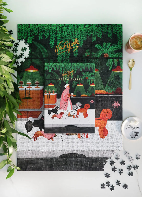 The Dog Sitter Puzzle by All the Ways to Say – Illustration of a woman walking dogs in New York, surrounded by lush greenery.