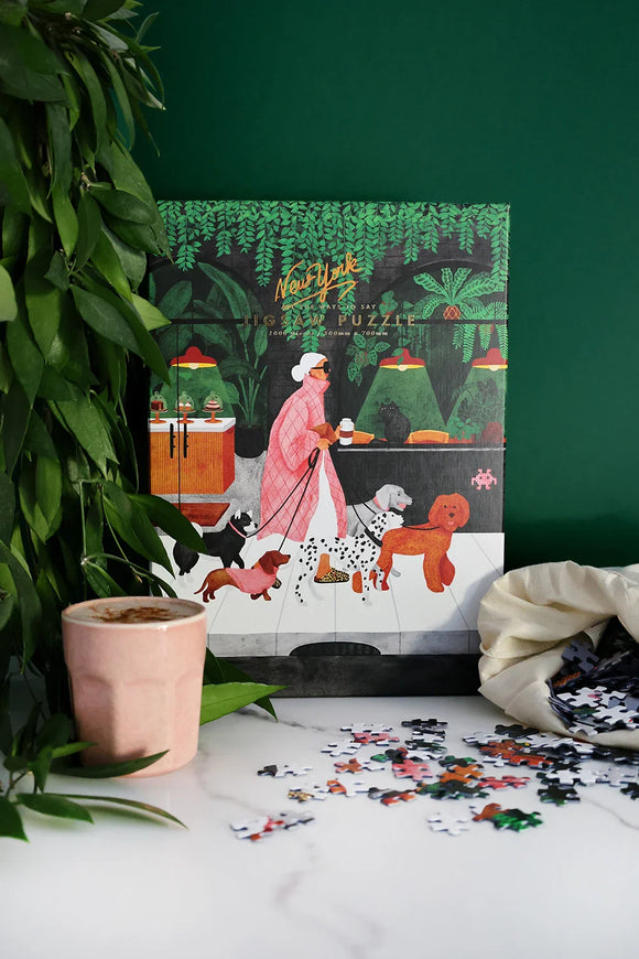 Close-up of The Dog Sitter puzzle pieces showing vibrant colors and detailed artwork of dogs and plants.