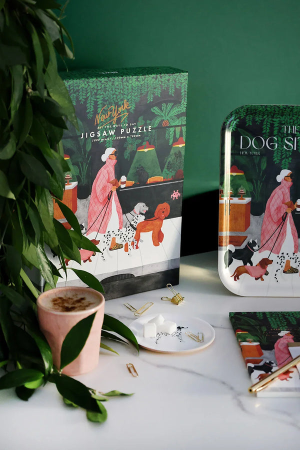 Completed The Dog Sitter puzzle with its box placed on top, showing New York-inspired illustration.