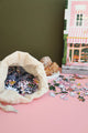 Cup of espresso with a few Pink Bakery puzzle pieces on the saucer — cozy breakfast puzzle setup by All the Ways to Say.