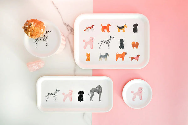 Stylish set of dog-themed trays in white with pink and orange tones, displayed on a marble and pink surface — charming and modern kitchen decor.